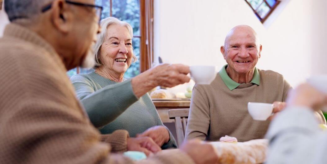 Group of Happy Seniors Enjoying Coffee in an Independent Living Facility