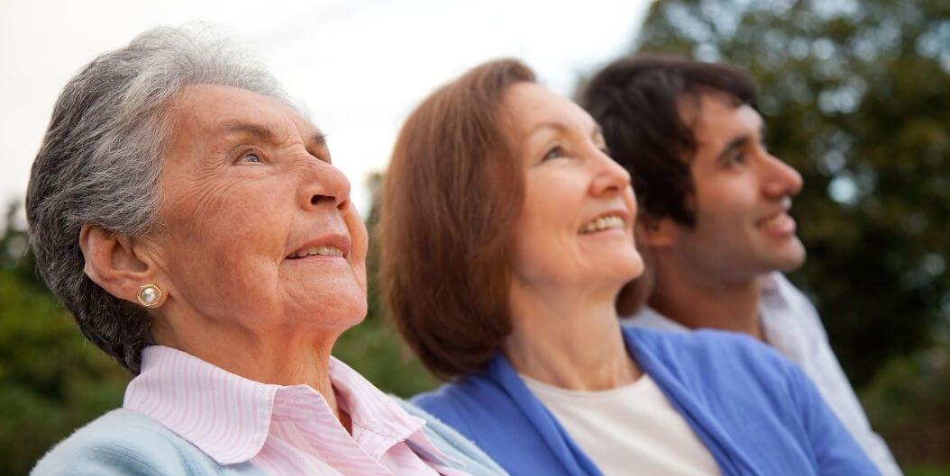 Elderly Family Looking at View with Smiles at Independent Living Facility