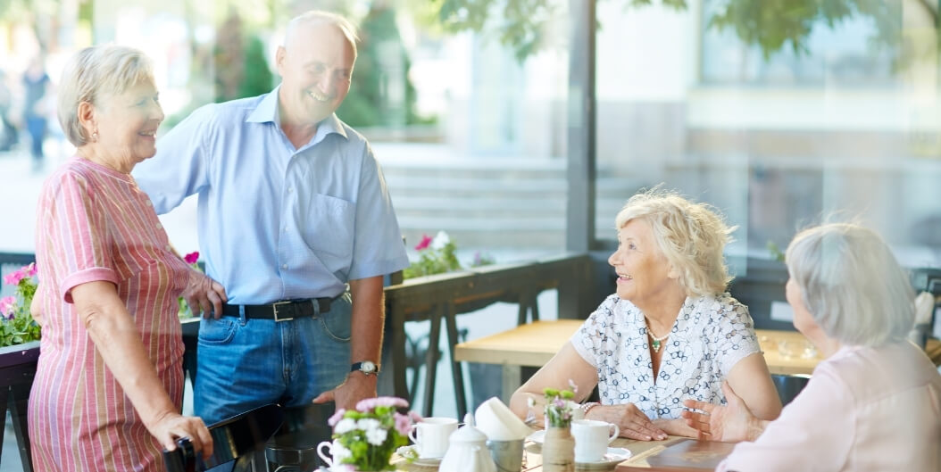 Group of Seniors Socializing at an Outdoor Cafe at an Independent Living Facility