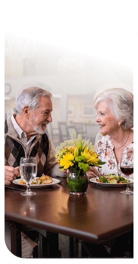 Elderly Couple Enjoying Lunch Together in the Dining Room at an Independent Living Community