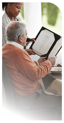 Attentive Server Helping an Elderly Man Review the Menu at an Independent Living Facility