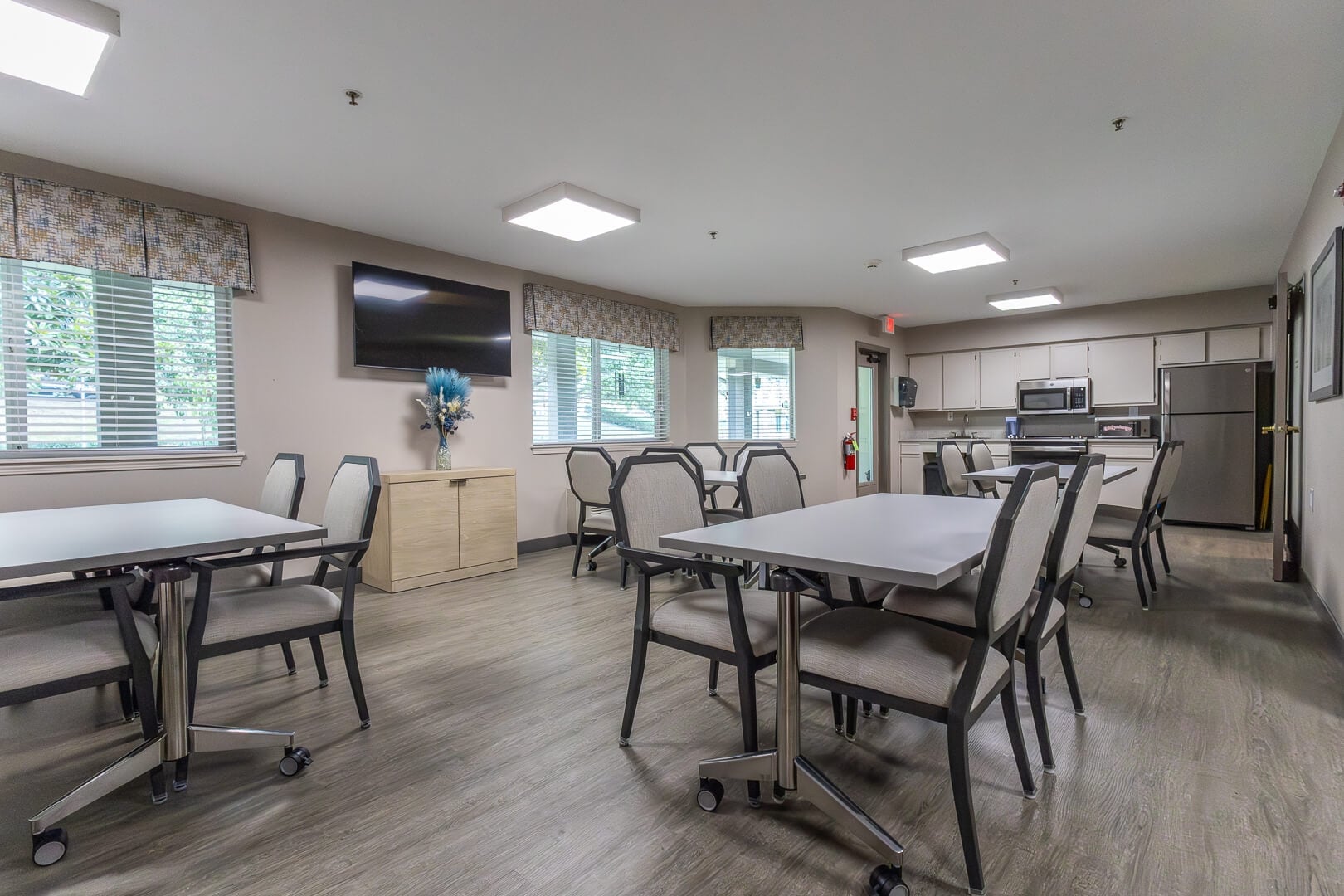 Casual Dining and Activity Room with Wall-Mounted TV at an Independent Living Community