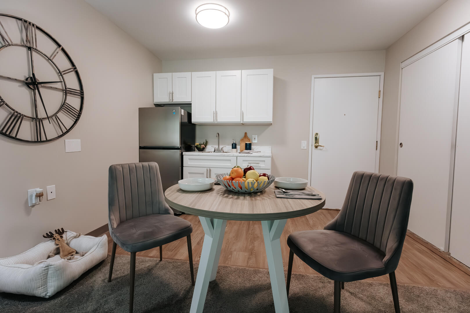 Cozy Studio Dining Nook with Kitchenette and Stainless Refrigerator at an Independent Living Facility