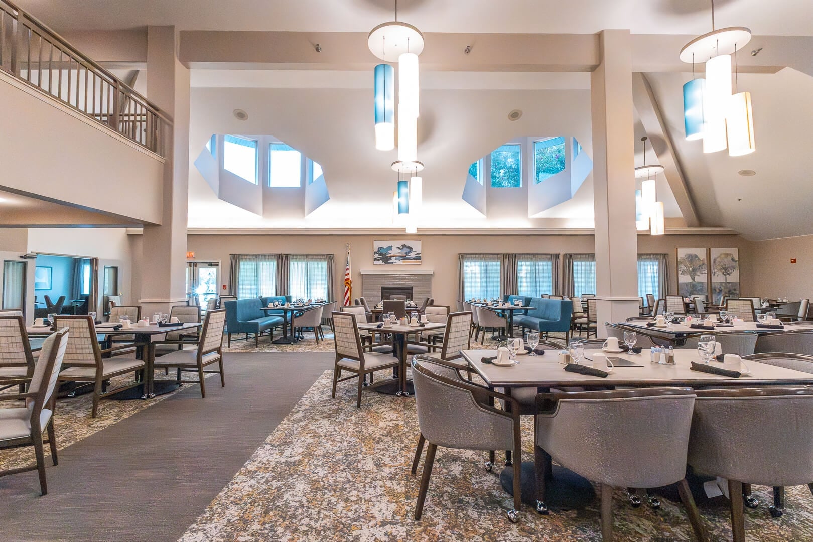 Spacious Dining Room with Vaulted Ceilings and Stone Fireplace at an Independent Living Community