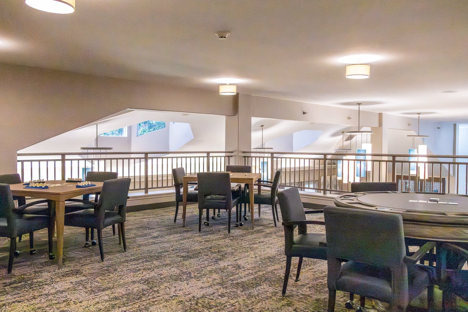 Upper-Level Dining Area with Set Tables and Open Railing at an Independent Living Community