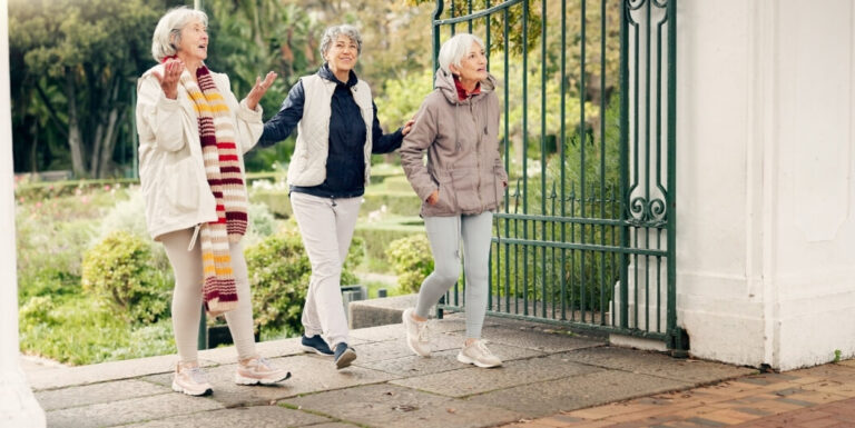 Elderly Women Strolling through Garden Gate in Tyler at Independent Living Facility