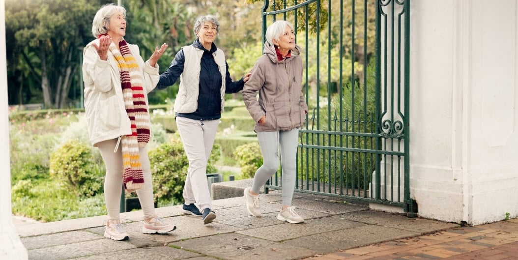 Elderly Women Strolling through Garden Gate in Tyler at Independent Living Facility